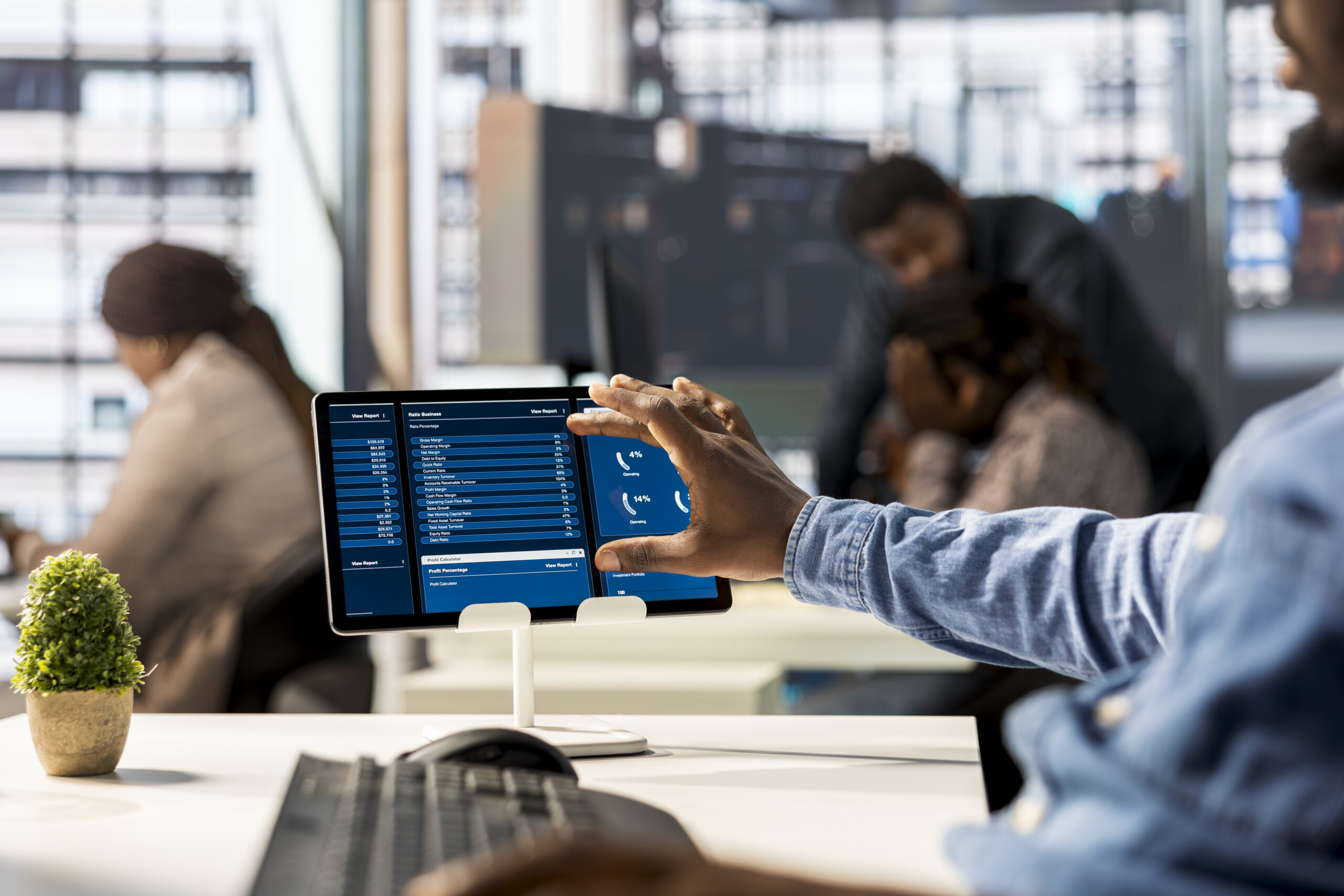 African American skilled analyst reviewing monthly revenue balance